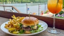 burger and fries on plate with drink in front of Delaware River