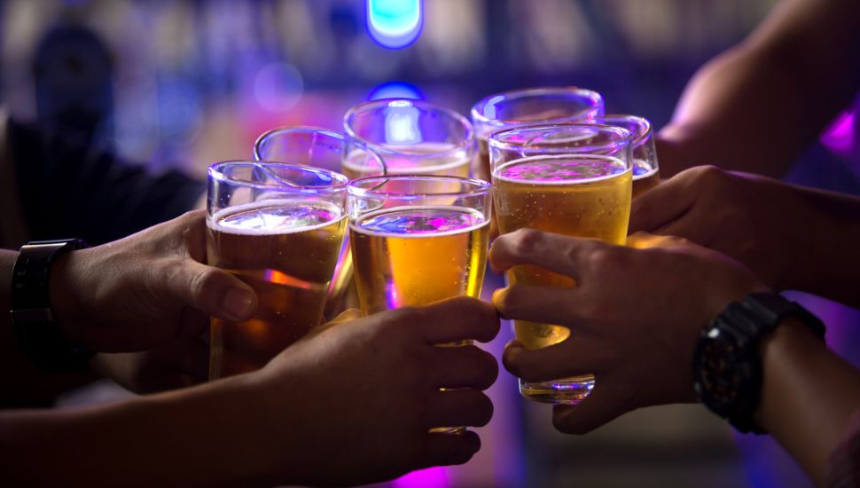 people cheering with beers