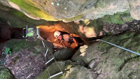 interior of cave looking up at excavator