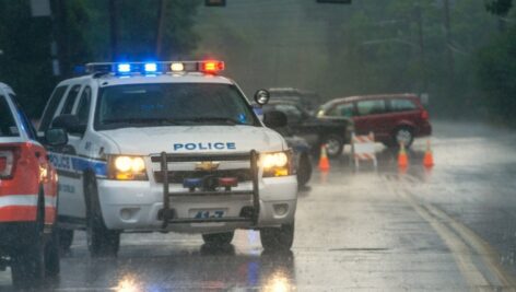 police car in rain on street