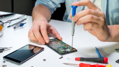 man fixing electronics