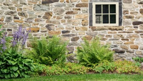 An old stone wall and rustic window.