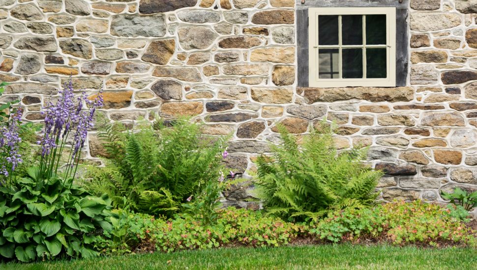 An old stone wall and rustic window.