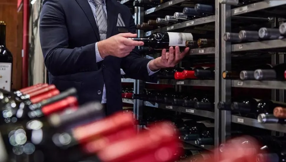 a sommelier selecting wine at one of the new restaurants in Bucks County.