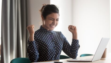 Happy woman celebrating a pay raise.