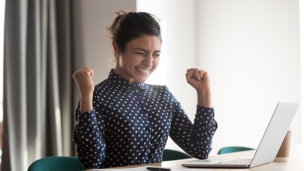 Happy woman celebrating a pay raise.