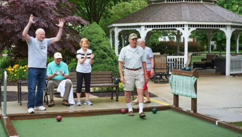 Freedom Village residents play a round of bocce.