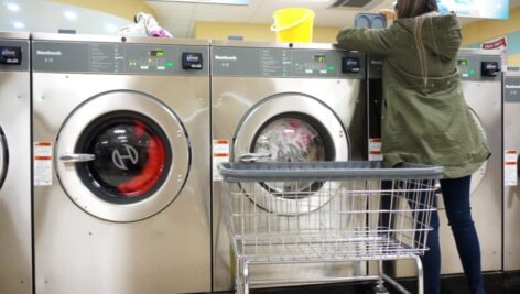 woman doing her laundry at The Laundry Cafe