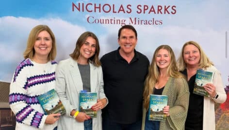 Nicholas Sparks poses with fans of his latest book.