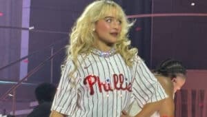 Sabrina Carpenter on stage with a bejeweled Phillies jersey.