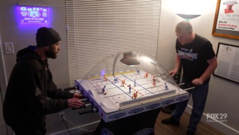 men playing bubble hockey