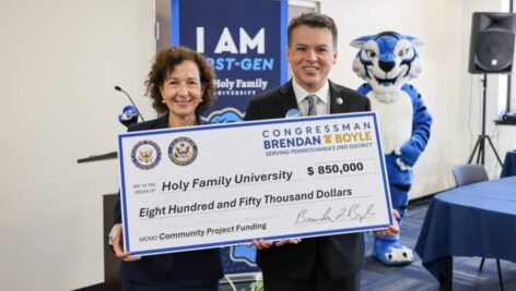 U.S. Rep. Brendan Boyle presents Holy Family President Dr. Anne Prisco with an $850,000 check.