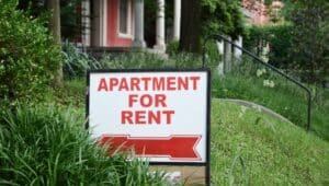 Apartment for rent sign displayed on residential street