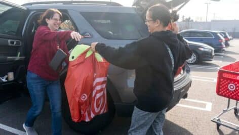 Christina Rago, from Morrisville, left, takes a bag full of goods from Angela Lancos, from New Jersey.