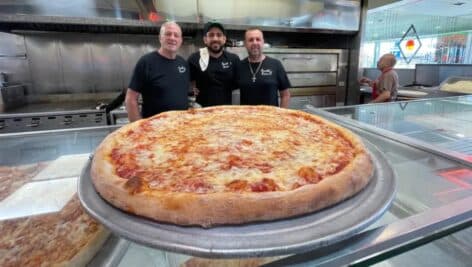 At Covello's Pizza are (from left) Frank Covello, Sr. with grandson, Frank, Jr. and, son, Giuseppe.