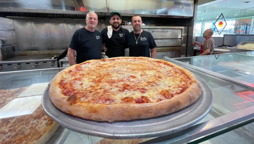 At Covello's Pizza are (from left) Frank Covello, Sr. with grandson, Frank, Jr. and, son, Giuseppe.