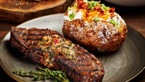 Firebirds Wood Fired Grill steak and baked potato dish.