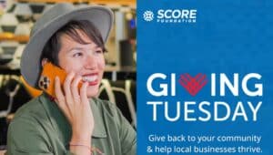 A woman on the phone with a promotion from SCORE Bucks County to volunteer as a mentor this Giving Tuesday.