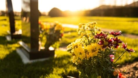 Grave marker and flowers in a cemetery.