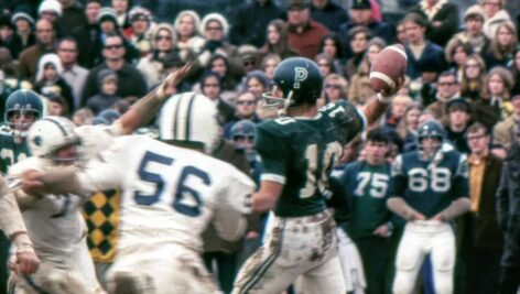 Jeff Hollenbach tossing a football.