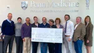 Members of A Love for Life and Penn Medicine holding $100,000 check.