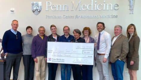 Members of A Love for Life and Penn Medicine holding $100,000 check.