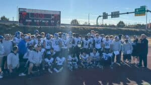 Conwell-Egan High School football team lines up on the field for group photo.