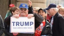 Donald Trump supporter holds Make America Great Again sign