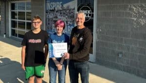 Pictured is Free Fall Action Sports Executive Director Dave Kratz (right) with two local students.