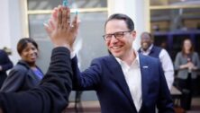 Governor Josh Shapiro high-fives a supporter.