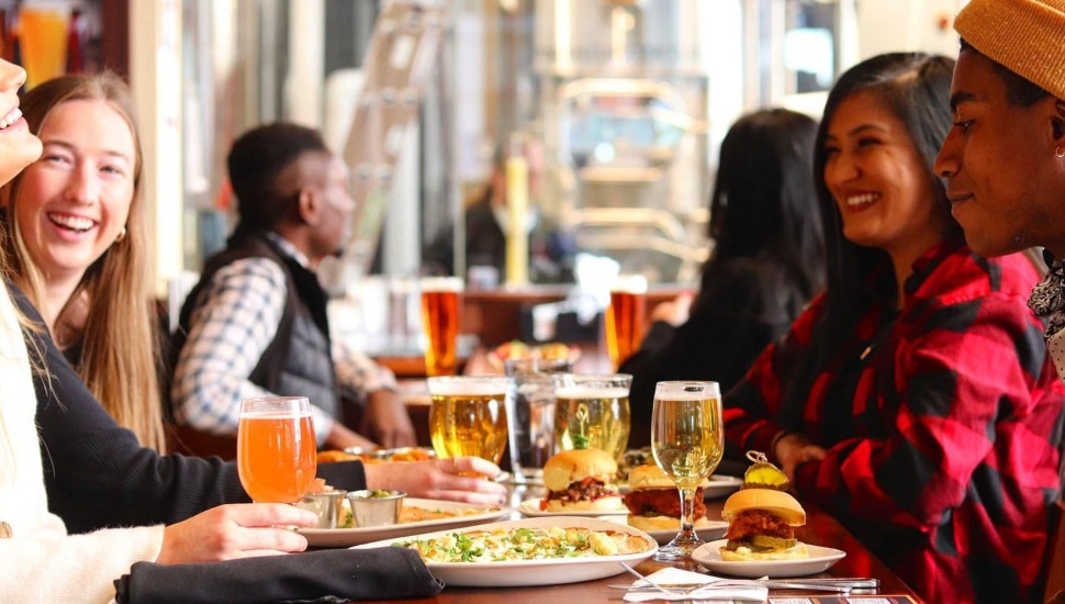 People enjoying food and drinks at Iron Hill Brewery.