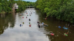 An aerial view of kayakers floating down the Perkiomen Creek.