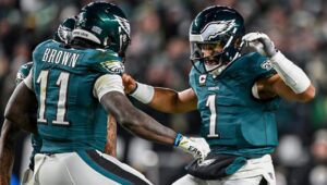 Eagles' Jalen Hurts and AJ Brown celebrating after touchdown.