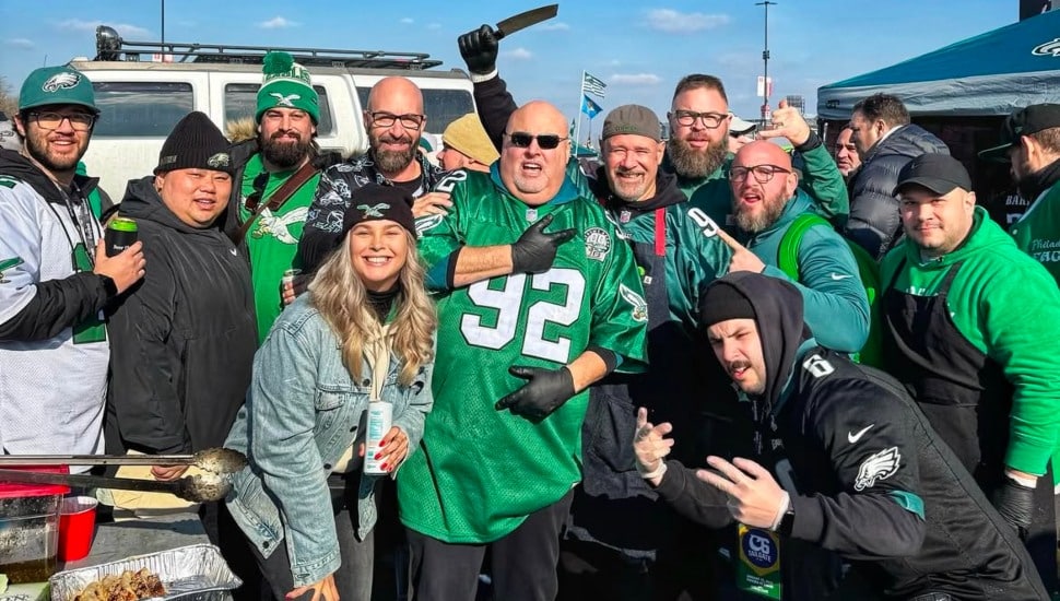 Eagles fans tailgating with Eagles gear on at C6 Tailgate.