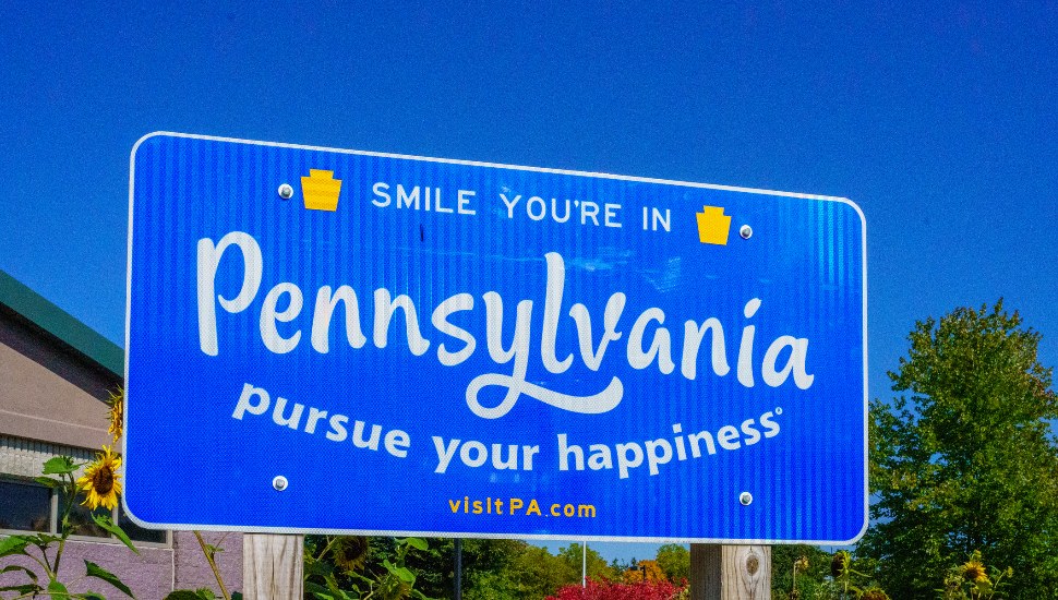 A blue 'Welcome to Pennsylvania' sign.