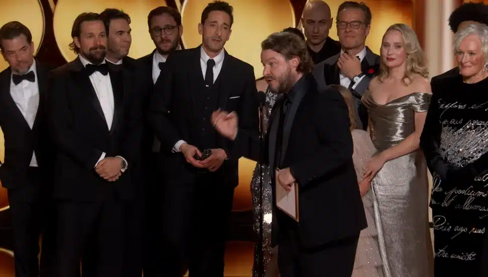 The writers and cast of "The Brutalist" on stage after winning a Golden Globe.