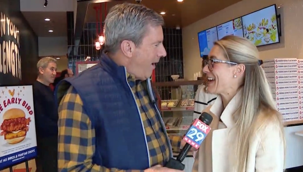 Television reporter interviews banking executive.