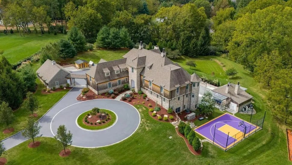 Malvern mansion aerial view with basketball court and big driveway.