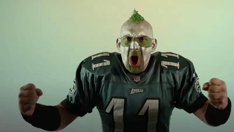Philly Sports Guy in an Eagles jersey and green and white face paint.
