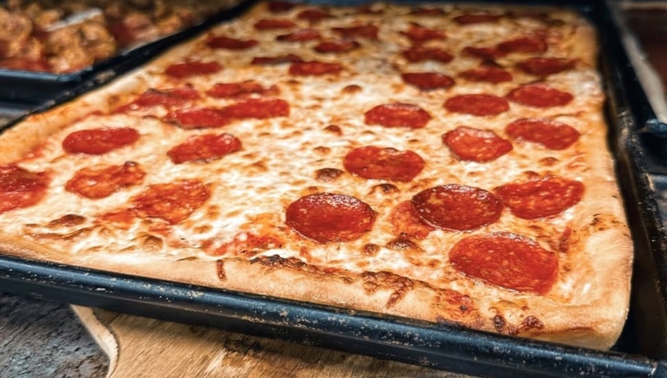 A pizza inside an oven from Santucci;s.