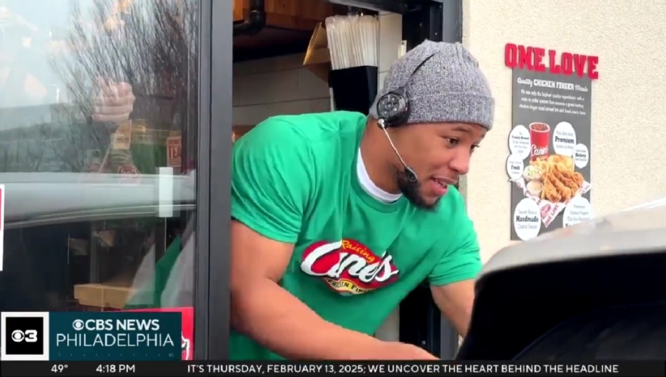 Saquon Barkley delivering food from a drive-thru at Raising Cane's.