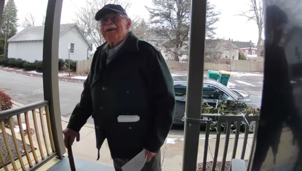 Doug Turner delivers an invitation for his winter party to his neighbor.