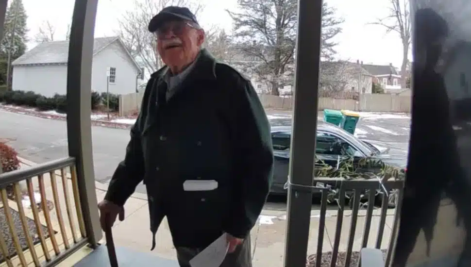 Doug Turner delivers an invitation for his winter party to his neighbor.