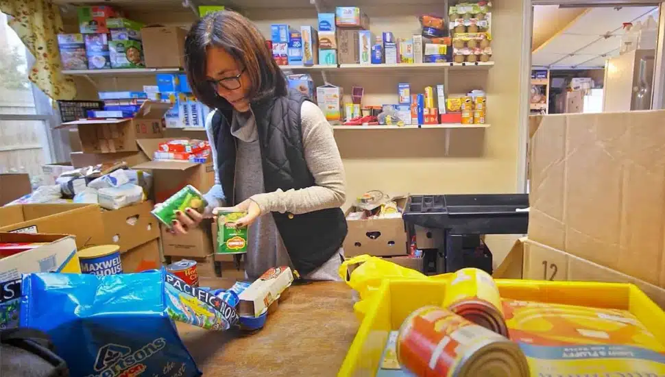 A parent taking food out a box.
