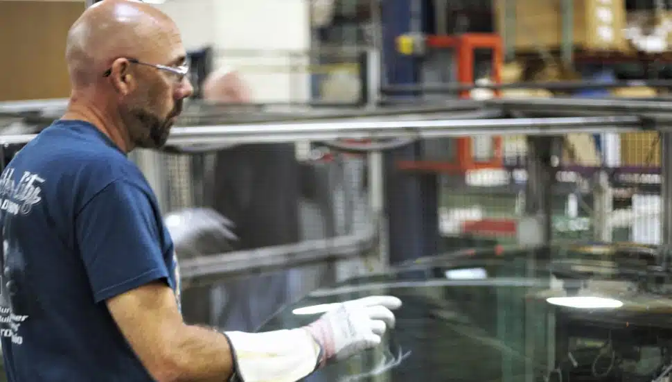 Man on Custom Glass Solutions manufacturing line