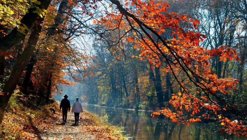 Two peole walk along the Delaware Canal Towpath.