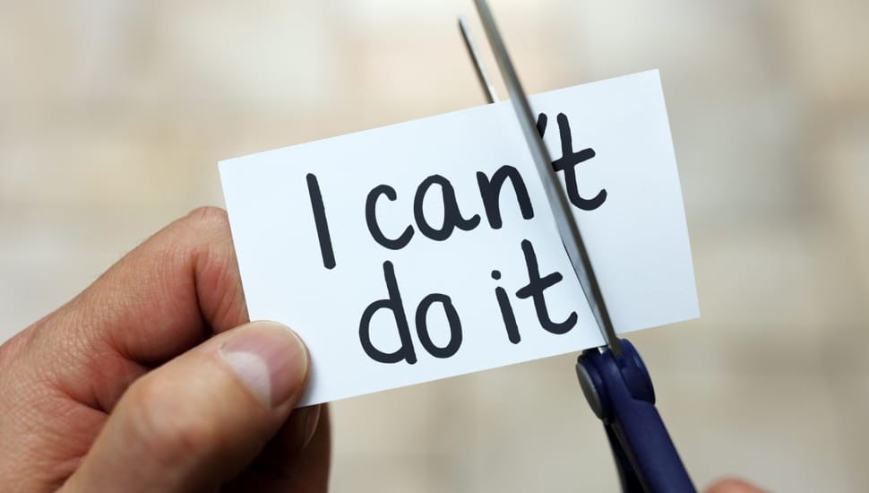 Man turns I Can't into I Can with scissors.
