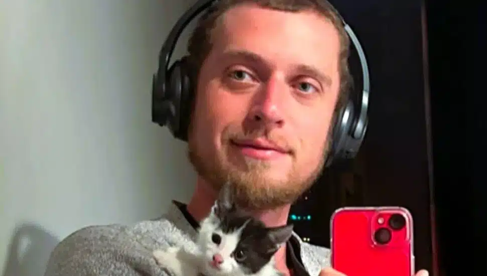 Justin Anderson listening to music holding his kitten