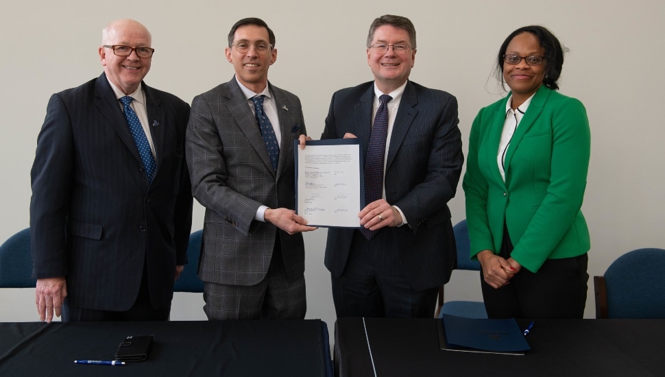 Administrators from two colleges sign pathway agreement.