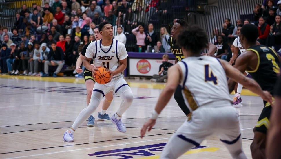 WCU men's basketball on the court at a game.